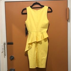 Yellow, asymmetrical peplum dress. Size small.